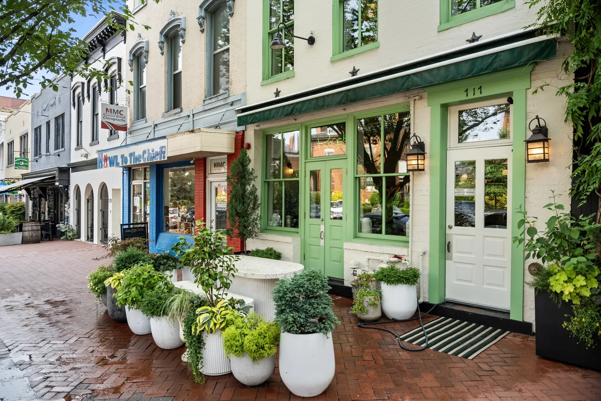 Charming Washington DC shopfront street with planters and brick sidewalks — neighborhood photography that sells the location, by Umedia