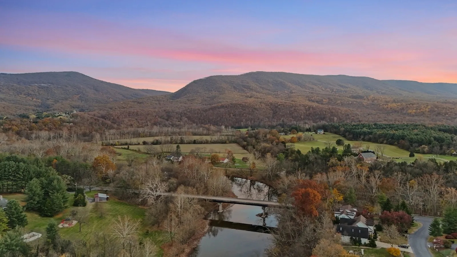 Aerial drone photograph showing a residential property and its surrounding neighborhood
