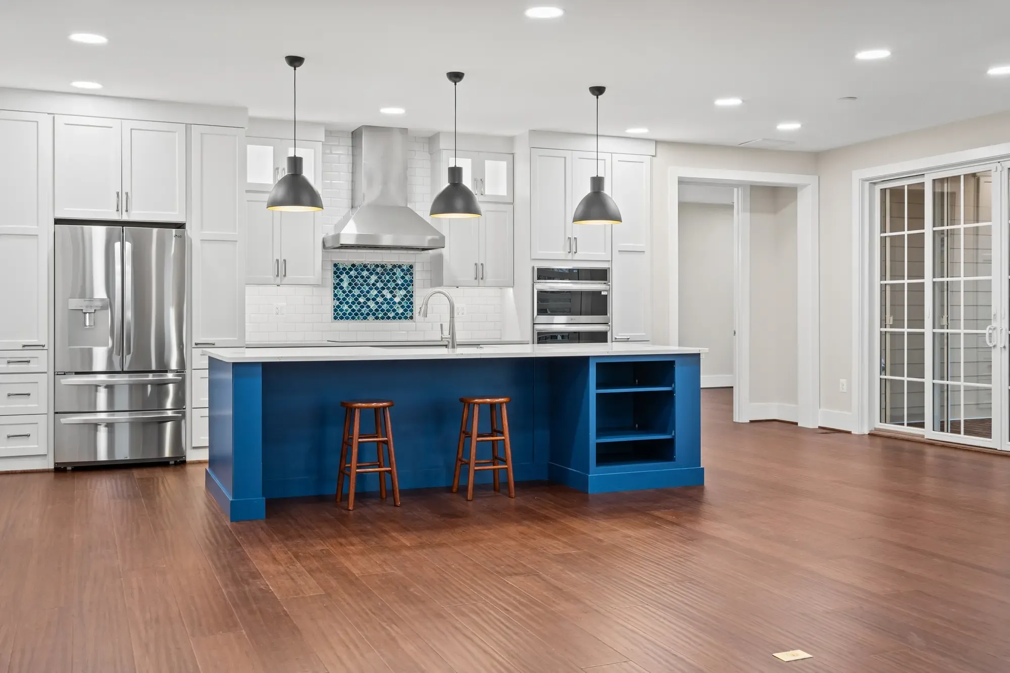 Renovated modern kitchen with white cabinets and marble counters in Falls Church