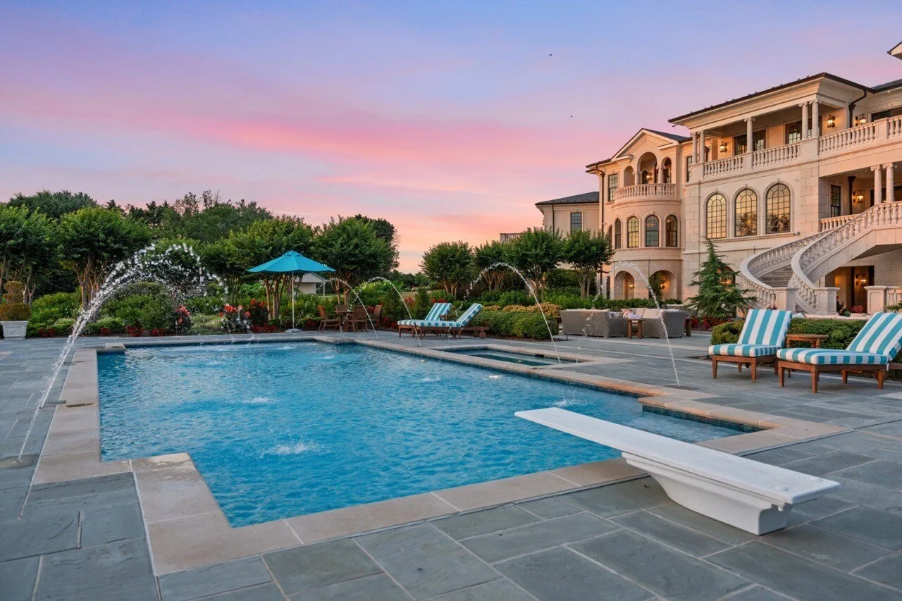 Twilight photograph of a luxury estate pool and rear exterior — Luxury Premier listing media