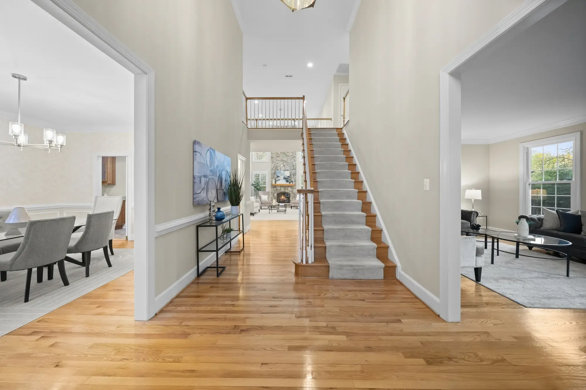 Elegant entryway with hardwood floors and warm lighting in Oakton VA home