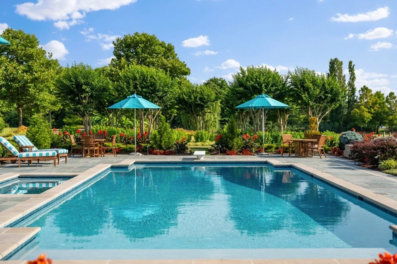 Resort-style pool with spa, striped loungers, and turquoise umbrellas — premium amenity photography for a luxury short-term rental by Umedia