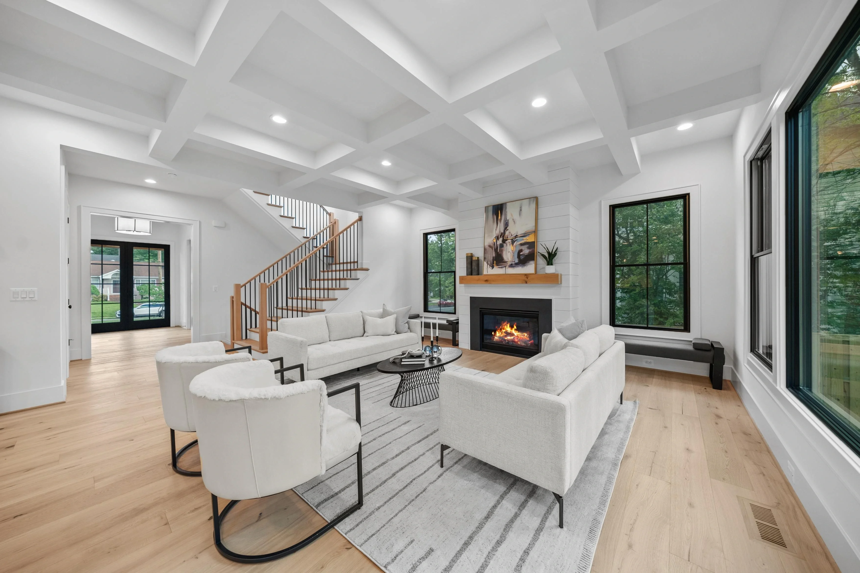 Staged living room with fireplace and coffered ceiling
