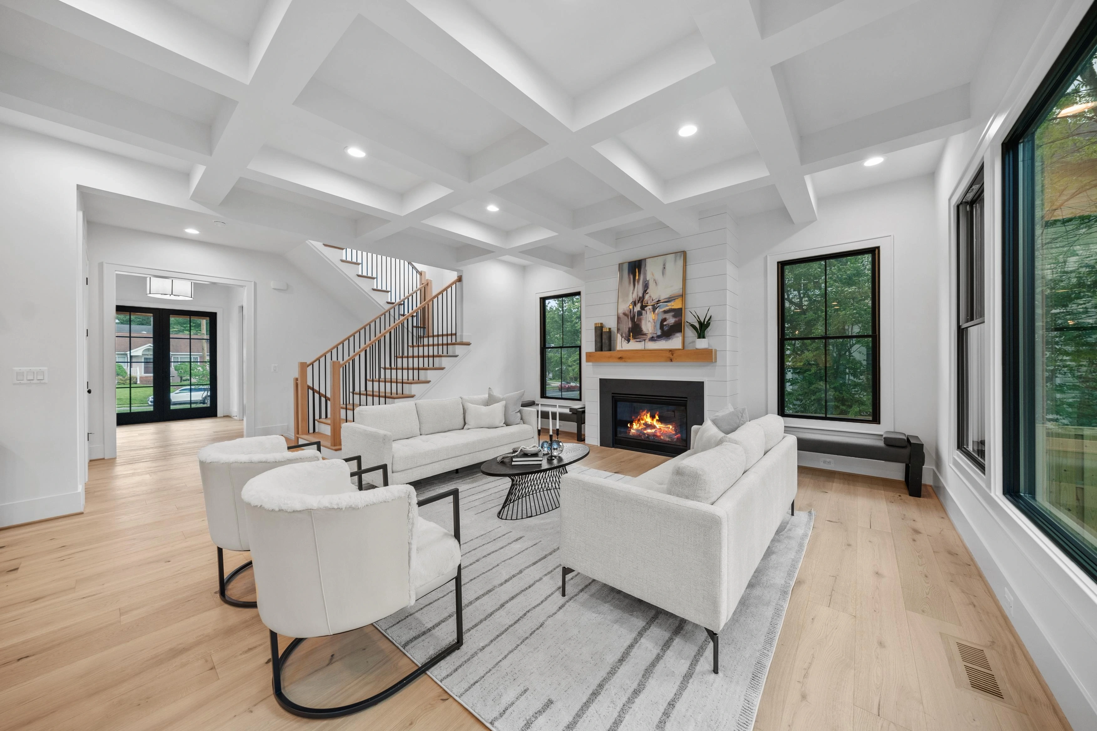 Staged living room with fireplace and coffered ceiling