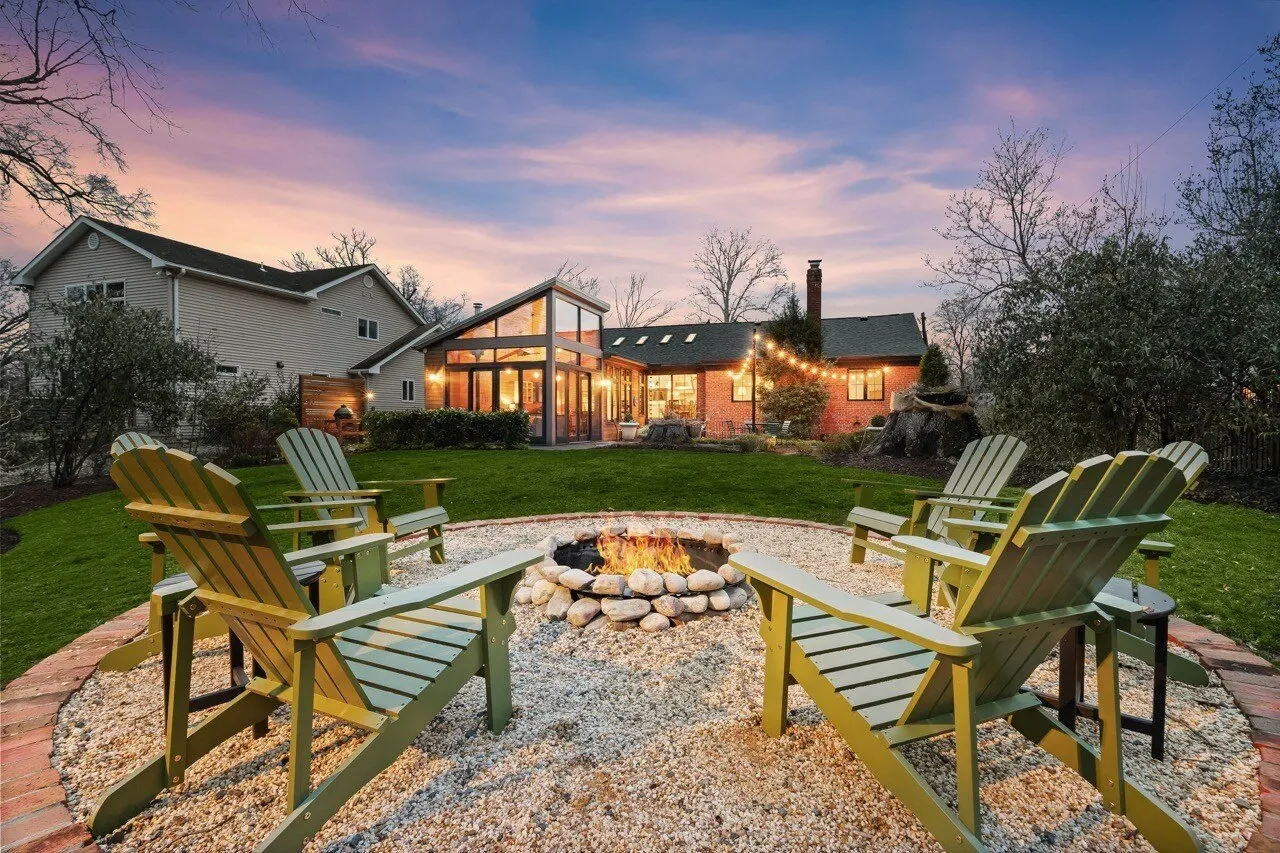 Cozy backyard fire pit with Adirondack chairs and string lights at twilight — the stay guests book, photographed by Umedia