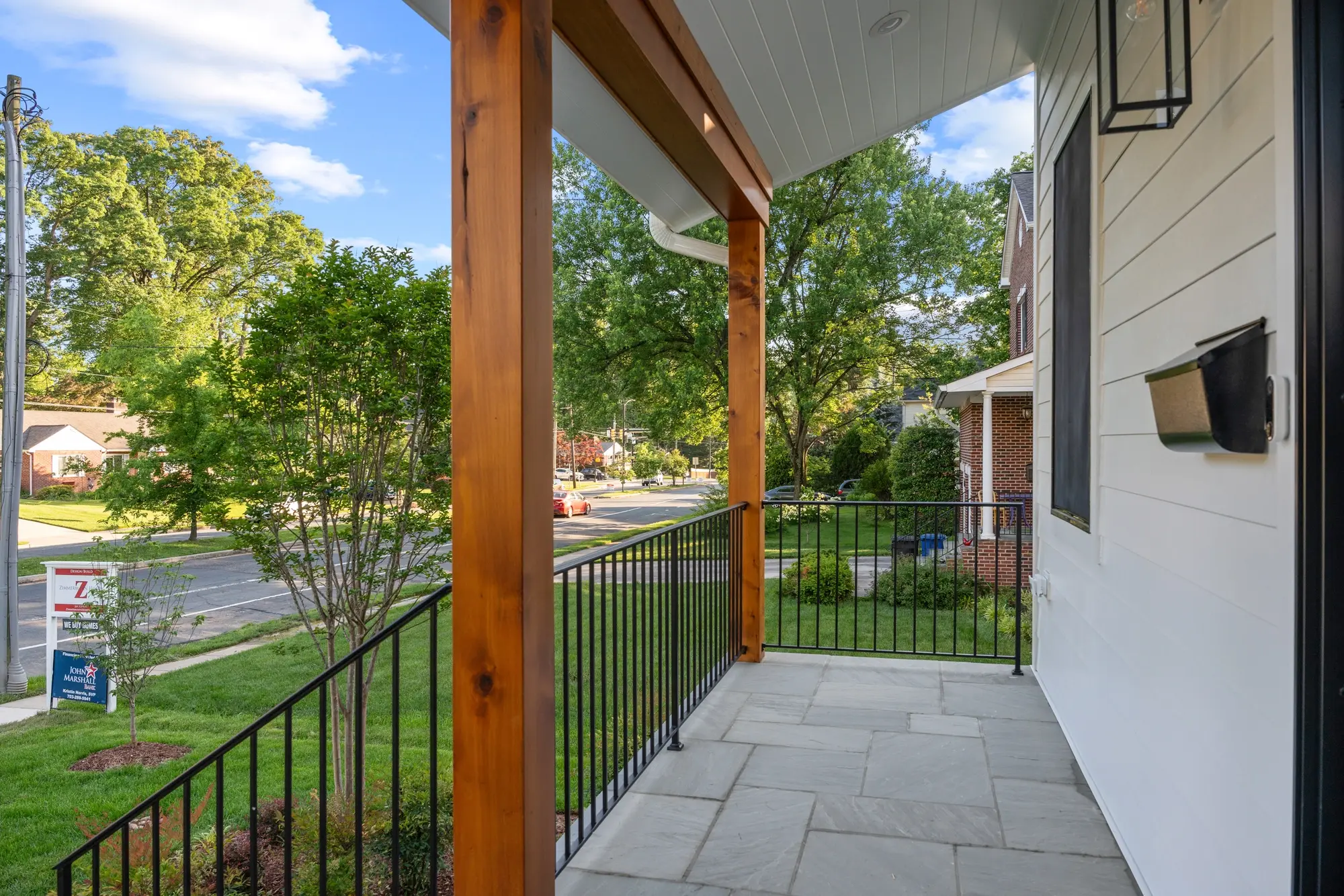Cozy reading nook with vaulted ceiling, large black-framed window, and accent rug