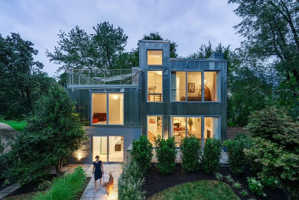 Modern eco house in the woods at twilight — editorial architectural photography by Umedia