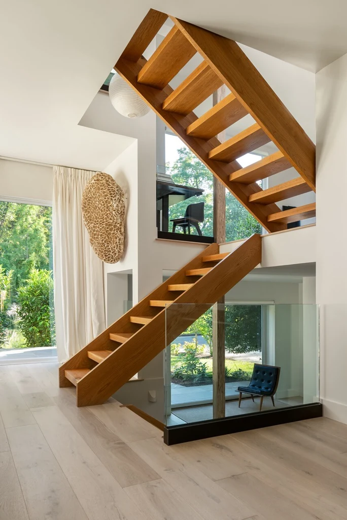 Vertical interior shot — staircase and natural light in modern eco house